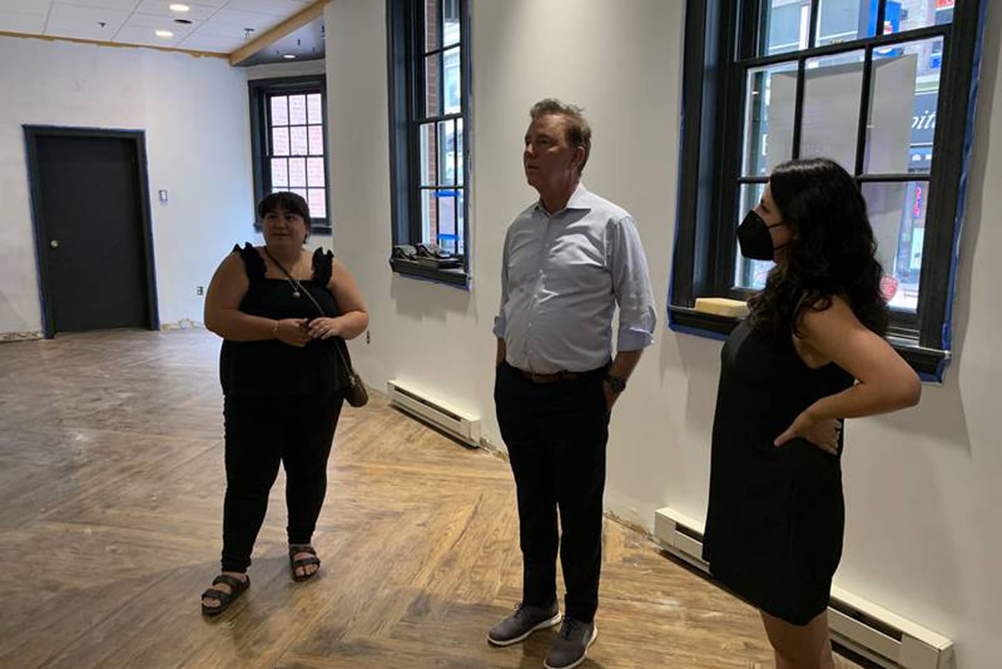 Gov. Ned Lamont visits the storefront space on Pratt Street where sisters Monica Beaudoin, left, and Alex Pilon plan to open a bakery and coffee shop by the end of the summer.